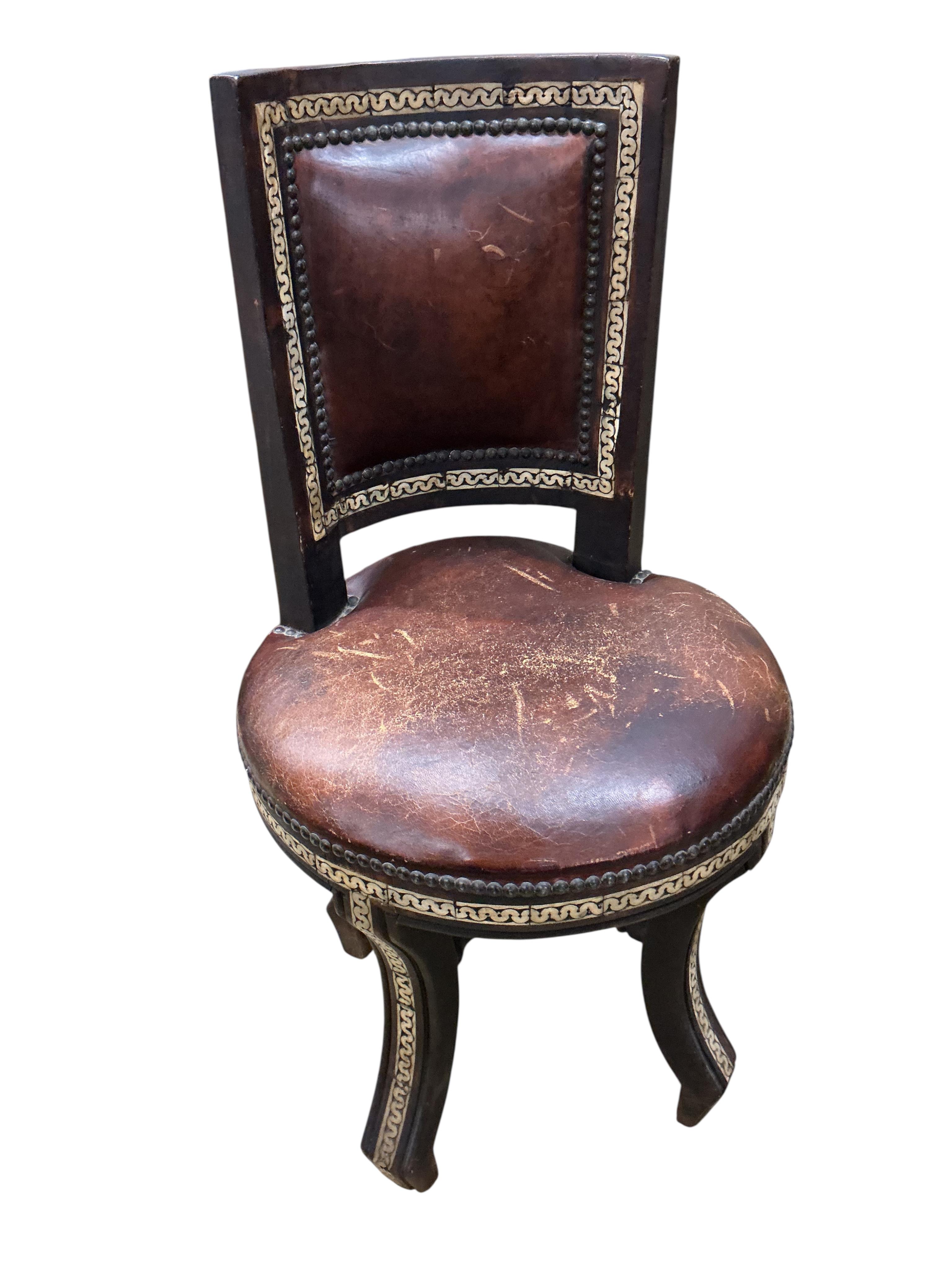 A Moroccan circular studded cedar glass top bistro table, diameter 80cm, height 76cm together with two matching chairs